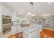 Open kitchen featuring granite counters, an island, and stainless appliances at 2629 Goldbug Ave, Sullivans Island, SC 29482