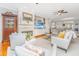 Cozy living room with a fireplace, built-in shelving, and a view to the kitchen at 2629 Goldbug Ave, Sullivans Island, SC 29482