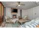 Relaxing living room with a fireplace, television, cozy seating, and access to the outdoors at 2629 Goldbug Ave, Sullivans Island, SC 29482