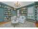 Charming living room boasts custom bookshelves, a decorative chandelier, and a cozy sitting area at 2629 Goldbug Ave, Sullivans Island, SC 29482