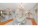 Bright open-concept living space features dining area, living room with fireplace, and a modern white kitchen at 2629 Goldbug Ave, Sullivans Island, SC 29482