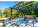 A charming outdoor patio with a pergola, comfortable seating, and lush greenery offers a relaxing retreat at 2629 Goldbug Ave, Sullivans Island, SC 29482