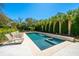 Beautiful pool area featuring a stone deck, spa, and waterfall surrounded by lush landscaping and lounge chairs at 2629 Goldbug Ave, Sullivans Island, SC 29482