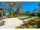 An inviting pool is surrounded by lush landscaping and lounge chairs, creating a backyard oasis at 2629 Goldbug Ave, Sullivans Island, SC 29482