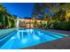 A backyard pool featuring waterfall design with lounge chairs and lush surroundings at 2629 Goldbug Ave, Sullivans Island, SC 29482
