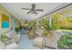 Large screened porch offers comfortable seating, a ceiling fan, and beautiful views of the surrounding landscape at 2629 Goldbug Ave, Sullivans Island, SC 29482