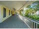 Spacious porch with wooden floors and railings offering ample room for relaxing and enjoying the outdoor views at 2629 Goldbug Ave, Sullivans Island, SC 29482