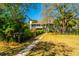 A beautifully landscaped front yard with a walkway leading to the charming home at 2629 Goldbug Ave, Sullivans Island, SC 29482