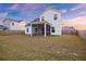 Backyard view with a screen porch and a partial fence at dusk at 265 Lucca Dr, Summerville, SC 29486