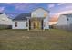 Backyard view features a well-maintained lawn and a screened porch, perfect for enjoying the outdoors at 265 Lucca Dr, Summerville, SC 29486