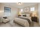 Comfortable bedroom with stylish bedding, a cozy chair, and warm, natural lighting at 265 Lucca Dr, Summerville, SC 29486