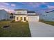 Charming two-story home with a well-manicured lawn and attached two-car garage, complemented by a beautiful twilight sky at 265 Lucca Dr, Summerville, SC 29486