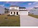 Two-story home with white siding, attached garage and manicured lawn at 265 Lucca Dr, Summerville, SC 29486