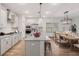 Open-concept kitchen and dining area with modern appliances, pendant lighting, a dining table, and hardwood floors at 265 Lucca Dr, Summerville, SC 29486