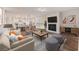 Stylishly decorated living room featuring a sofa, armchairs, fireplace, and an open kitchen with a dining area at 265 Lucca Dr, Summerville, SC 29486