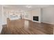 Open living space with wood floors, a fireplace, and a view into the bright and modern kitchen at 265 Lucca Dr, Summerville, SC 29486