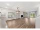 Open-concept living area features hardwood floors, a fireplace, and large windows at 265 Lucca Dr, Summerville, SC 29486