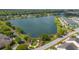 Community aerial view showcasing a large lake with surrounding homes, green spaces, and walking paths at 2743 Calico Bass Ln, Johns Island, SC 29455