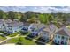 Aerial view of colorful homes featuring charming balconies, lush green spaces, and a well-maintained community at 2743 Calico Bass Ln, Johns Island, SC 29455