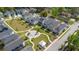 Aerial view of a vibrant neighborhood featuring a central park and a mix of colorful homes at 2743 Calico Bass Ln, Johns Island, SC 29455