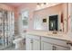 Bright bathroom with single sink vanity, patterned shower curtain, and soft pink walls at 2743 Calico Bass Ln, Johns Island, SC 29455