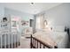 Cozy bedroom featuring a crib, a bed and a rocking chair with lots of natural light at 2743 Calico Bass Ln, Johns Island, SC 29455