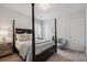 Well-lit bedroom with four-poster bed, ample natural light, and neutral decor at 2743 Calico Bass Ln, Johns Island, SC 29455