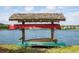 Close-up view of community canoe rack with red and green canoes over looking a peaceful lake at 2743 Calico Bass Ln, Johns Island, SC 29455