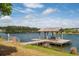 A wooden dock with seating overlooks a serene community lake under a sunny sky at 2743 Calico Bass Ln, Johns Island, SC 29455