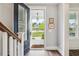Open entryway with a view to the porch with rocking chairs and a beautiful neighborhood view at 2743 Calico Bass Ln, Johns Island, SC 29455