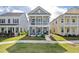 Charming two-story home with a double porch and inviting curb appeal set among green lawns on a sunny day at 2743 Calico Bass Ln, Johns Island, SC 29455