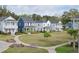 Charming neighborhood showcasing colorful homes, landscaping, and pathways at 2743 Calico Bass Ln, Johns Island, SC 29455