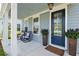 Charming front porch with rocking chairs, stylish planters, and a welcoming entrance creates an inviting outdoor area at 2743 Calico Bass Ln, Johns Island, SC 29455
