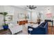 Elegant living room with stylish decor, plush seating, and a decorative ceiling fan at 2743 Calico Bass Ln, Johns Island, SC 29455