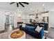 Open concept living room and kitchen with hardwood floors, modern lighting, and a stylish design at 2743 Calico Bass Ln, Johns Island, SC 29455