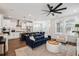 Open concept living room and kitchen with hardwood floors, modern lighting, and stainless steel appliances at 2743 Calico Bass Ln, Johns Island, SC 29455
