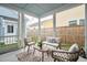 Charming screened patio features stylish seating, a decorative rug, and serene views of the backyard at 2743 Calico Bass Ln, Johns Island, SC 29455
