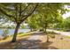 Scenic walking path next to a tranquil lake, lined with trees and community homes at 2743 Calico Bass Ln, Johns Island, SC 29455