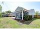 Grassy backyard featuring a screened-in porch and a small patio area, ideal for outdoor relaxation and entertaining at 2914 Glenarden Dr, Charleston, SC 29414