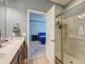Bathroom showcases a glass shower and is adjoined to a main bedroom with a blue bed at 2914 Glenarden Dr, Charleston, SC 29414