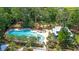 Aerial view of community pool featuring lounge chairs, umbrellas, and lush landscaping at 2914 Glenarden Dr, Charleston, SC 29414