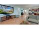 Open-concept living area featuring wood-look floors, large screen television, and comfortable seating at 2914 Glenarden Dr, Charleston, SC 29414