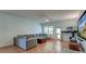 Bright living room features a gray sectional sofa, ceiling fan, and wood-look floors at 2914 Glenarden Dr, Charleston, SC 29414