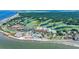 Stunning aerial view of the Atrium Villa complex, surrounded by lush golf courses and ocean views at 2933 Atrium Villa Dr # 33, Seabrook Island, SC 29455