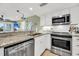 Modern kitchen with stainless steel appliances, granite countertops, and white cabinetry for a clean, stylish look at 2933 Atrium Villa Dr # 33, Seabrook Island, SC 29455