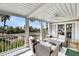 Relaxing screened porch with comfortable seating and views of the lush surroundings and palm trees at 2933 Atrium Villa Dr # 33, Seabrook Island, SC 29455