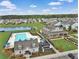 Aerial view of community amenities including a large pool, clubhouse, lake, and green spaces at 301 Dunlin Dr, Summerville, SC 29486