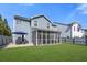 View of the home's backyard featuring a well-manicured lawn and a screened in porch at 301 Dunlin Dr, Summerville, SC 29486