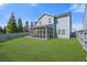 Expansive backyard features a well-maintained lawn and a screened in porch for outdoor enjoyment at 301 Dunlin Dr, Summerville, SC 29486