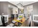 Dining room with glass table, modern chandelier, and view to living room at 301 Dunlin Dr, Summerville, SC 29486